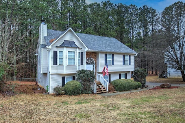 bi-level home with a front lawn