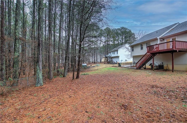 view of yard featuring central AC and a deck