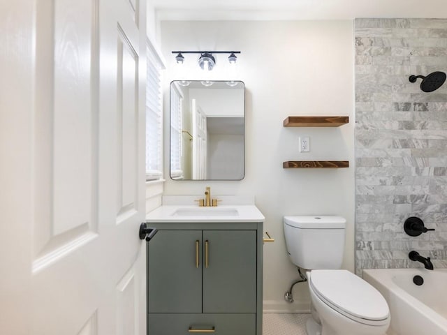 full bathroom featuring vanity, tiled shower / bath combo, and toilet