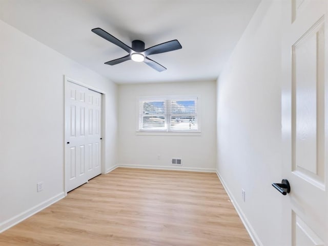 unfurnished bedroom with ceiling fan, light hardwood / wood-style floors, and a closet