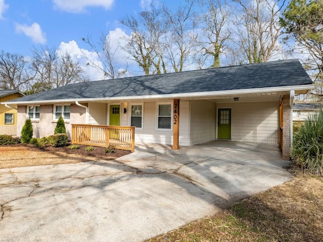 single story home featuring a carport and covered porch