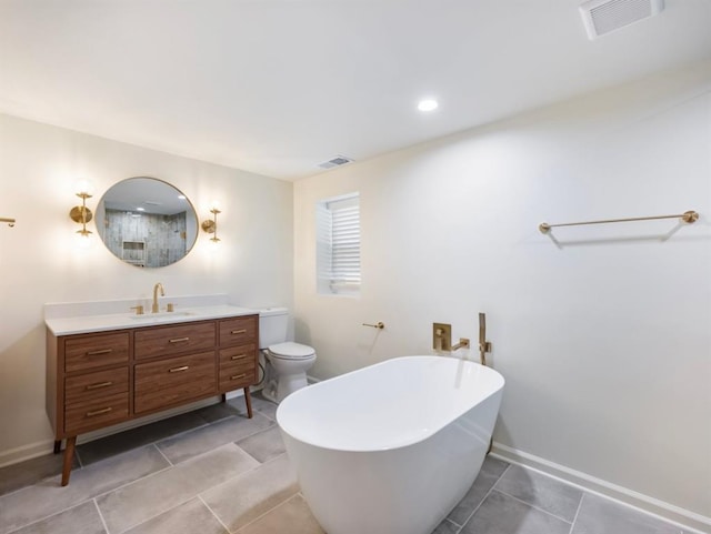 bathroom featuring tile patterned flooring, vanity, a bath, and toilet