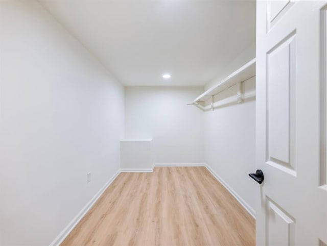 walk in closet featuring light hardwood / wood-style flooring