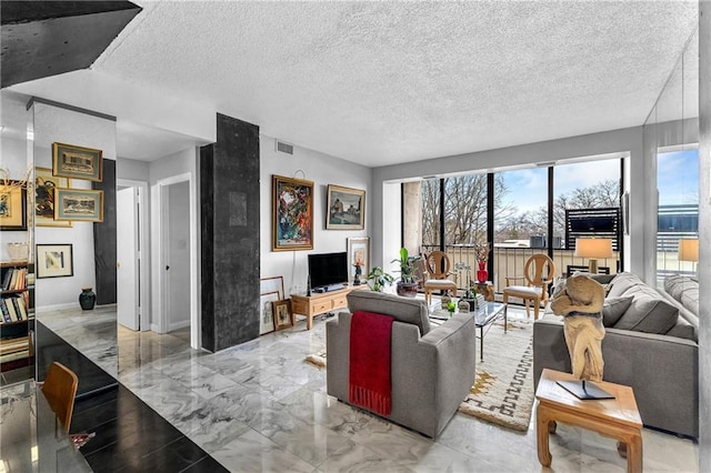 living area featuring marble finish floor, visible vents, a textured ceiling, and baseboards