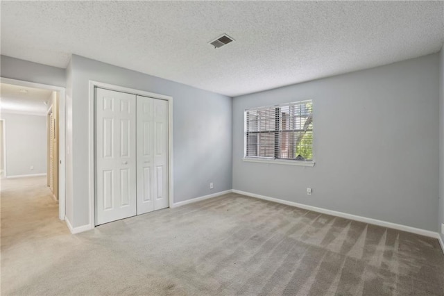 511 Barrington Hills Dr, Atlanta, GA 30350 - unfurnished bedroom featuring carpet, a closet, and a textured ceiling