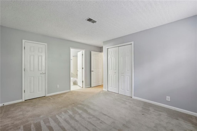 511 Barrington Hills Dr, Atlanta, GA 30350 - unfurnished bedroom with carpet floors, ensuite bath, a textured ceiling, and a closet