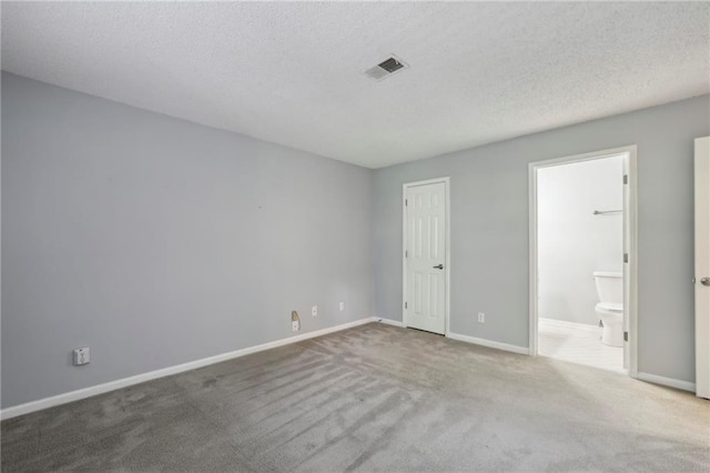 511 Barrington Hills Dr, Atlanta, GA 30350 - unfurnished bedroom featuring carpet flooring, a textured ceiling, and ensuite bath