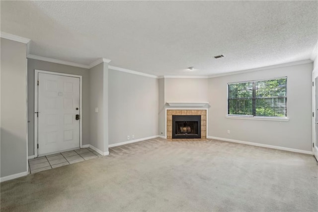 511 Barrington Hills Dr, Atlanta, GA 30350 - unfurnished living room featuring carpet floors, a textured ceiling, ornamental molding, a tiled fireplace, and tile patterned floors
