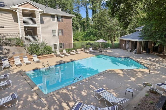 511 Barrington Hills Dr, Atlanta, GA 30350 - community pool featuring a patio area and view of scattered trees