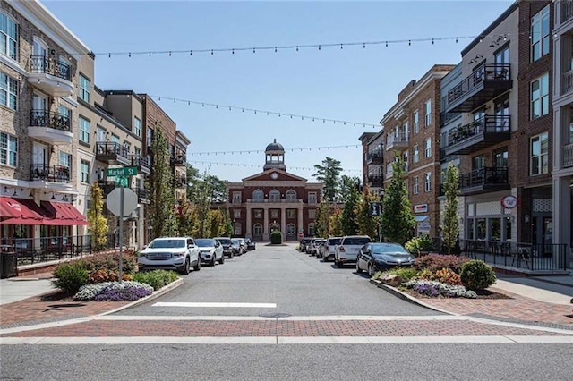 1210 Mayfield Rd, Milton, GA 30009 - view of asphalt street featuring sidewalks, curbs, traffic signs, and street lights