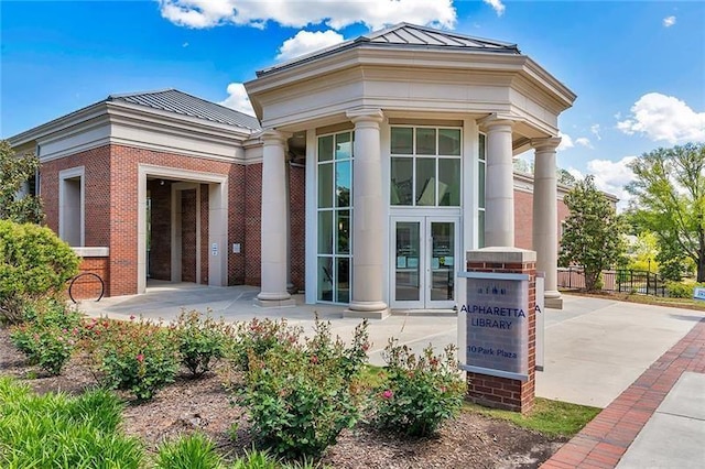 1210 Mayfield Rd, Milton, GA 30009 - property entrance with a standing seam roof, metal roof, and brick siding