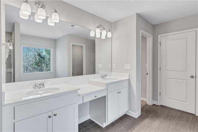 bathroom with double vanity, a sink, and baseboards