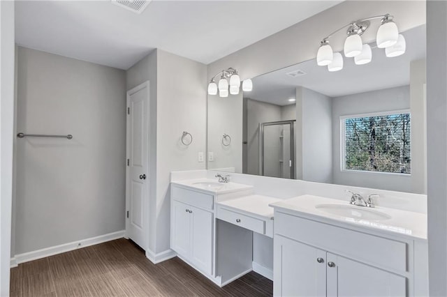 full bath featuring double vanity, a stall shower, visible vents, and a sink