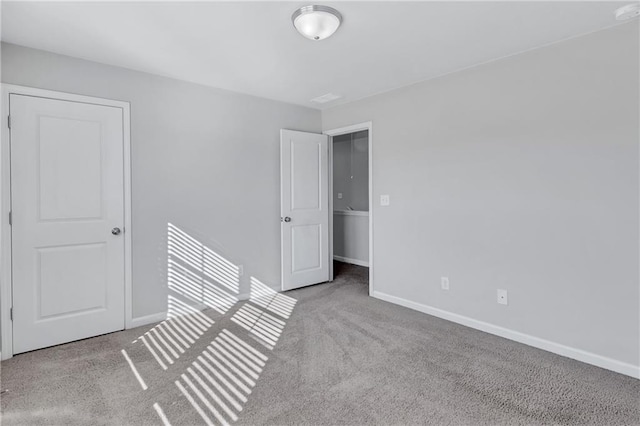 spare room featuring baseboards and light colored carpet