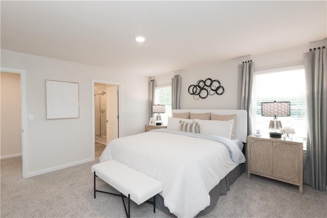 carpeted bedroom featuring ensuite bathroom