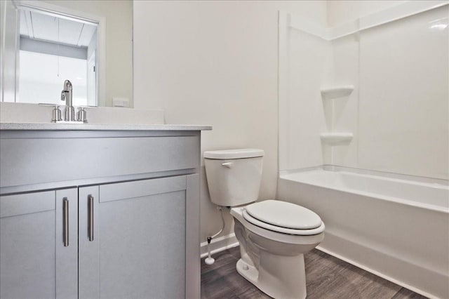 full bathroom with vanity, hardwood / wood-style flooring, bathtub / shower combination, and toilet