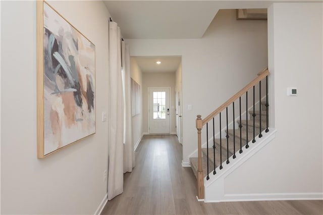 foyer entrance with light hardwood / wood-style floors