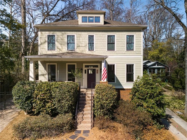 american foursquare style home with a porch