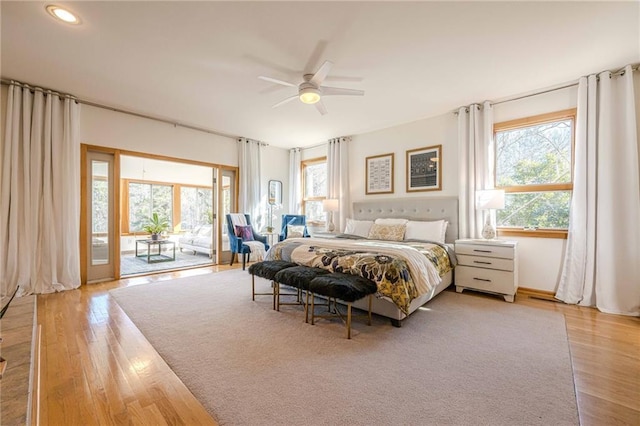 bedroom featuring ceiling fan, access to exterior, and light hardwood / wood-style flooring