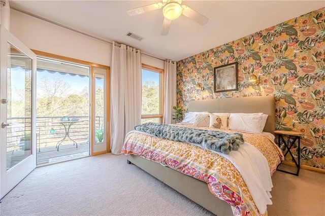 carpeted bedroom featuring ceiling fan, access to exterior, and multiple windows