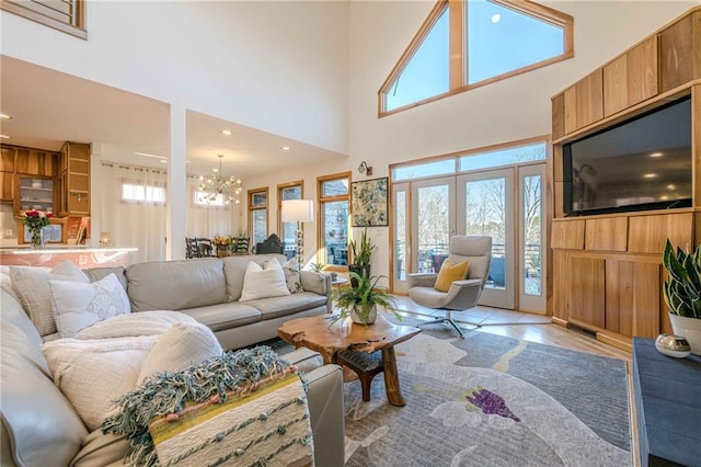 tiled living room featuring french doors, a notable chandelier, and a high ceiling