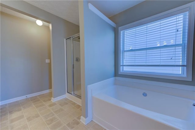 922 Gardenia Curv, Canton, GA 30114 - bathroom with a shower stall, tile patterned flooring, baseboards, and a garden tub