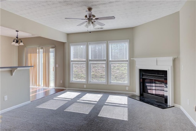 922 Gardenia Curv, Canton, GA 30114 - unfurnished living room featuring ceiling fan with notable chandelier, carpet, a glass covered fireplace, visible vents, and baseboards
