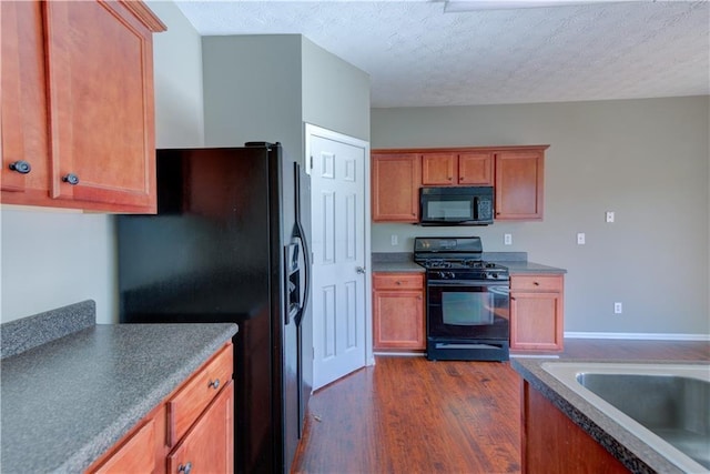 922 Gardenia Curv, Canton, GA 30114 - kitchen featuring a sink, a textured ceiling, dark wood-type flooring, brown cabinetry, and black appliances