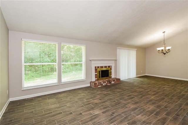 unfurnished living room with lofted ceiling, a chandelier, and a fireplace