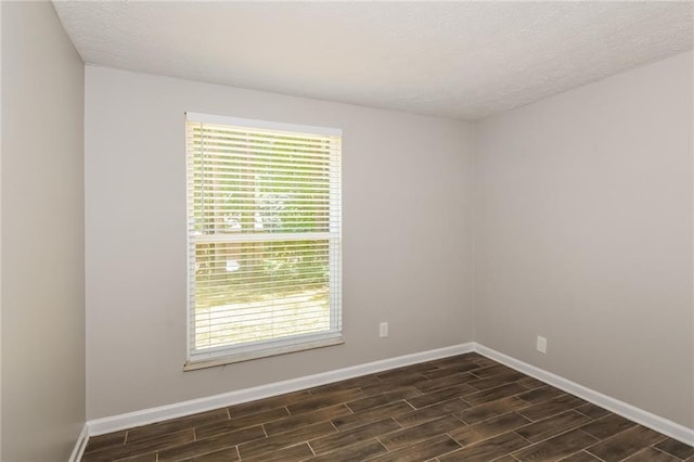 unfurnished room with a wealth of natural light and a textured ceiling