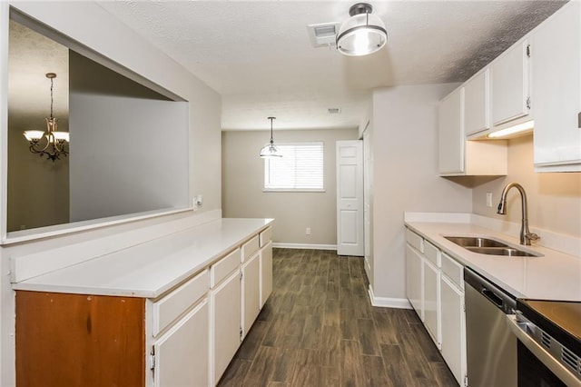 kitchen featuring dark hardwood / wood-style floors, white cabinetry, sink, hanging light fixtures, and stainless steel appliances