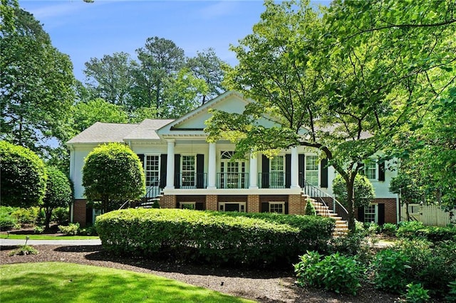 5545 Cross Gate Ct, Atlanta, GA 30327 - view of front facade with stairway, brick siding, and covered porch