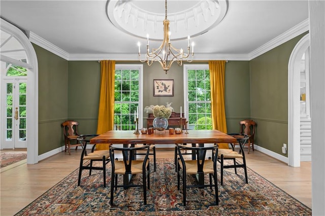 5545 Cross Gate Ct, Atlanta, GA 30327 - dining area with wood finished floors, ornamental molding, a chandelier, arched walkways, and baseboards