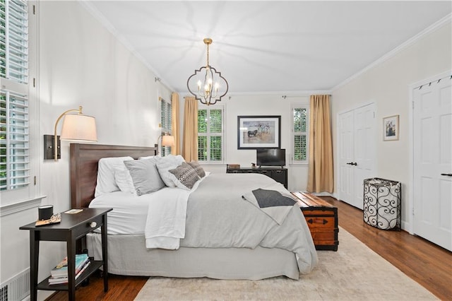 5545 Cross Gate Ct, Atlanta, GA 30327 - bedroom featuring crown molding, a chandelier, and wood finished floors