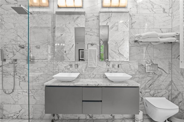 5545 Cross Gate Ct, Atlanta, GA 30327 - full bathroom featuring tile walls, double vanity, toilet, and a marble finish shower