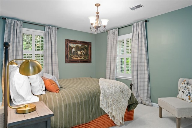 5545 Cross Gate Ct, Atlanta, GA 30327 - carpeted bedroom with multiple windows, a chandelier, and baseboards