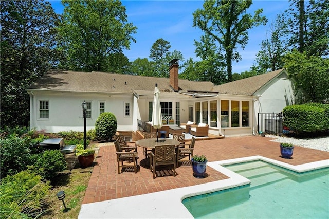 5545 Cross Gate Ct, Atlanta, GA 30327 - back of house with a chimney, a patio, stucco siding, and an outdoor pool