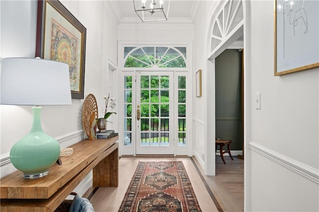 5545 Cross Gate Ct, Atlanta, GA 30327 - doorway featuring ornamental molding, a chandelier, and light wood-style floors