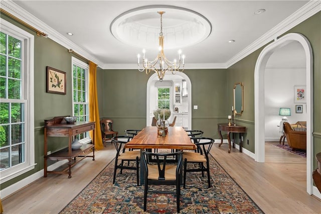 5545 Cross Gate Ct, Atlanta, GA 30327 - dining area featuring arched walkways, wood finished floors, ornamental molding, a chandelier, and baseboards