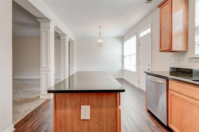 kitchen with decorative light fixtures, decorative columns, dishwasher, a center island, and dark carpet