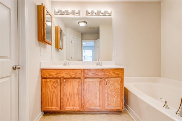 bathroom with tile patterned flooring, vanity, and a tub to relax in