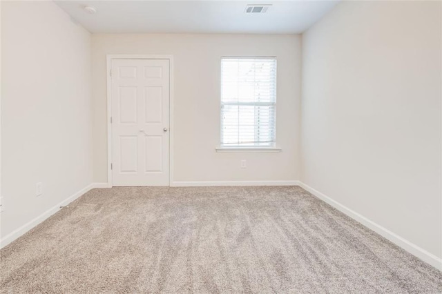 unfurnished room featuring light carpet