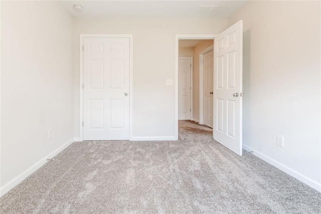 unfurnished bedroom with light carpet