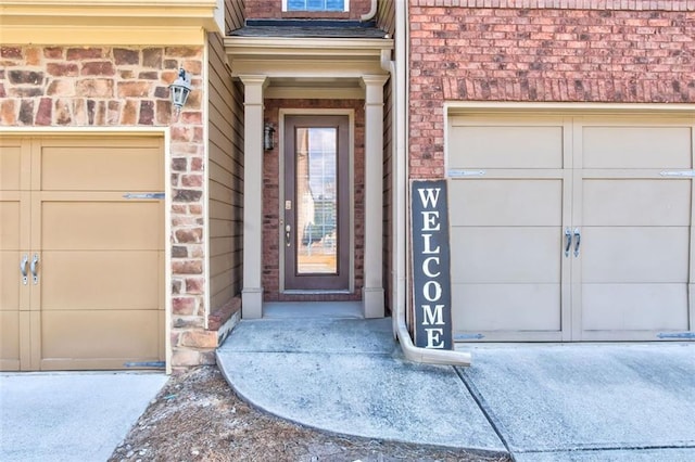 doorway to property with a garage