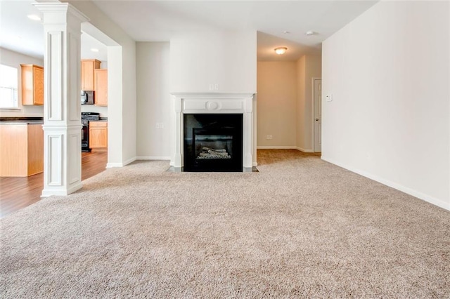 unfurnished living room with light carpet and ornate columns