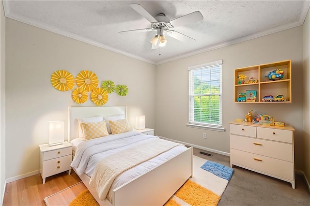 89 Cottonwood Loop, Dallas, GA 30132 - bedroom featuring crown molding, a ceiling fan, a textured ceiling, and light wood-type flooring