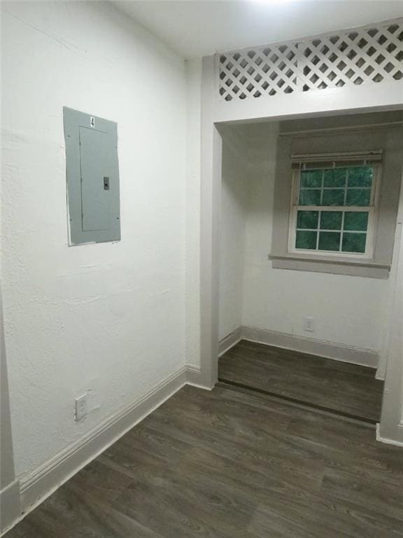 empty room featuring dark hardwood / wood-style floors and electric panel