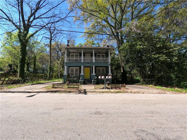 view of front of property with covered porch and a balcony