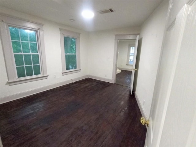 unfurnished room featuring dark hardwood / wood-style floors