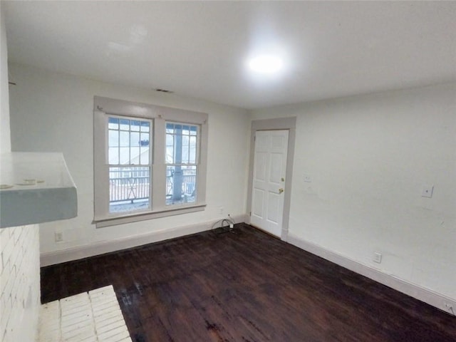 empty room featuring dark wood-type flooring